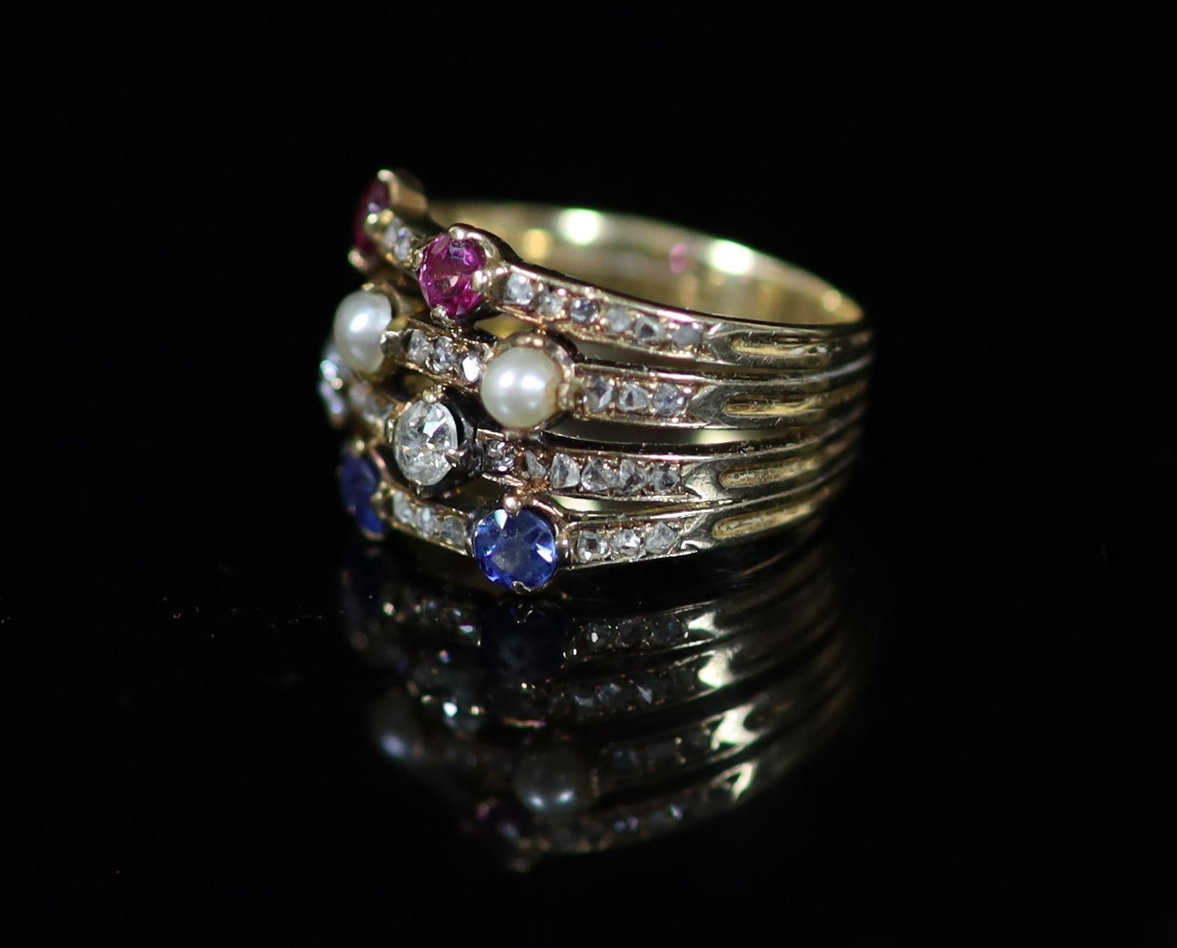 A mid 20th century gold, ruby, diamond sapphire and seed pearl set quadruple shank dress ring